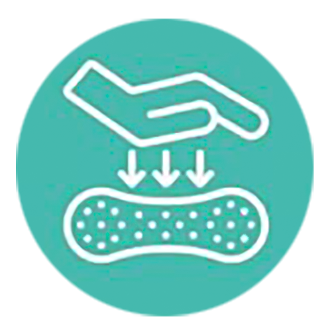 Hand pressing down on memory foam to demonstrate softness and support of Pyramid Pillow core